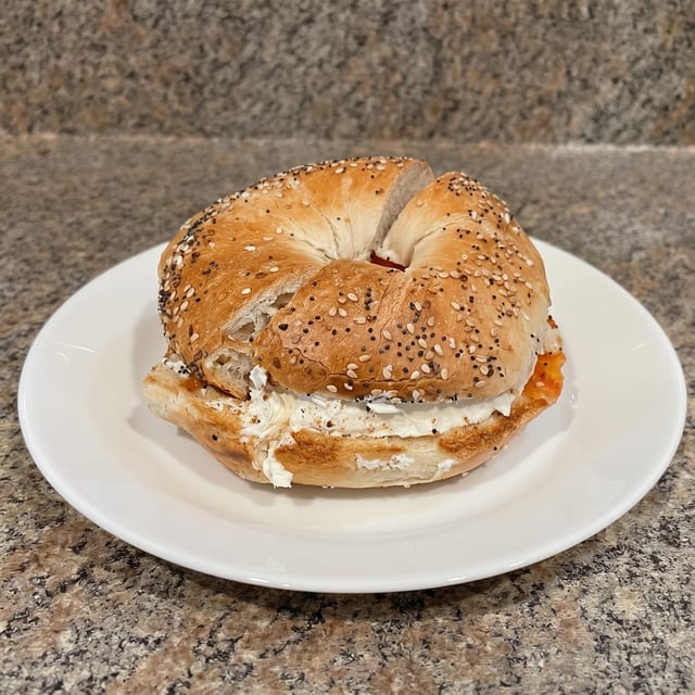 Nova Lox & Cream Cheese with Tomatoes & Onions Bagel.